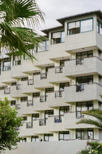Modern apartment building with balconies and trees.